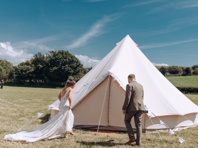Wedding couple approaching their bridal Bell Tent